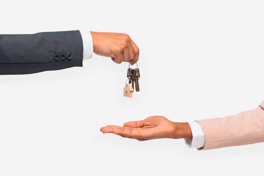 Hand giving key  real estate agent